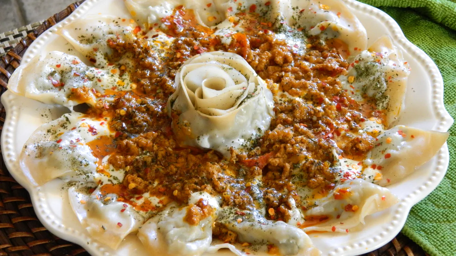 Ashak dumplings are filled with leeks and spices, steamed, and served with meat sauce and yogurt.