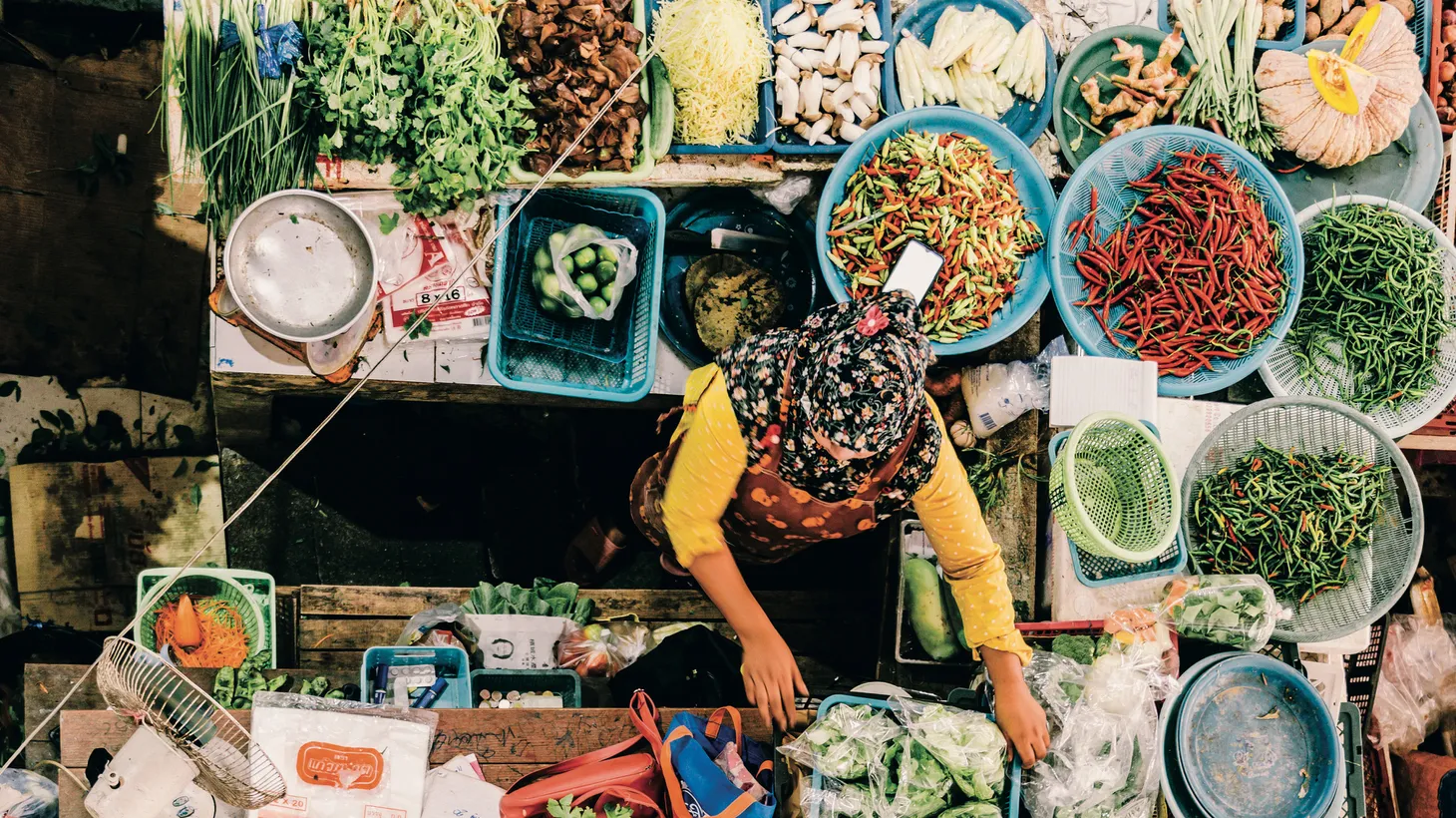 A woman sells vegetables in Southern Thailand.