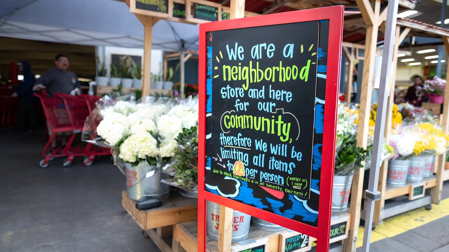 A sign at the entrance of Trader Joe’s in Culver City says, “We are a neighborhood store and here for our community.” It also reminds customers to limit themselves to two items each — at the start of the COVID-19 pandemic in March 2020.