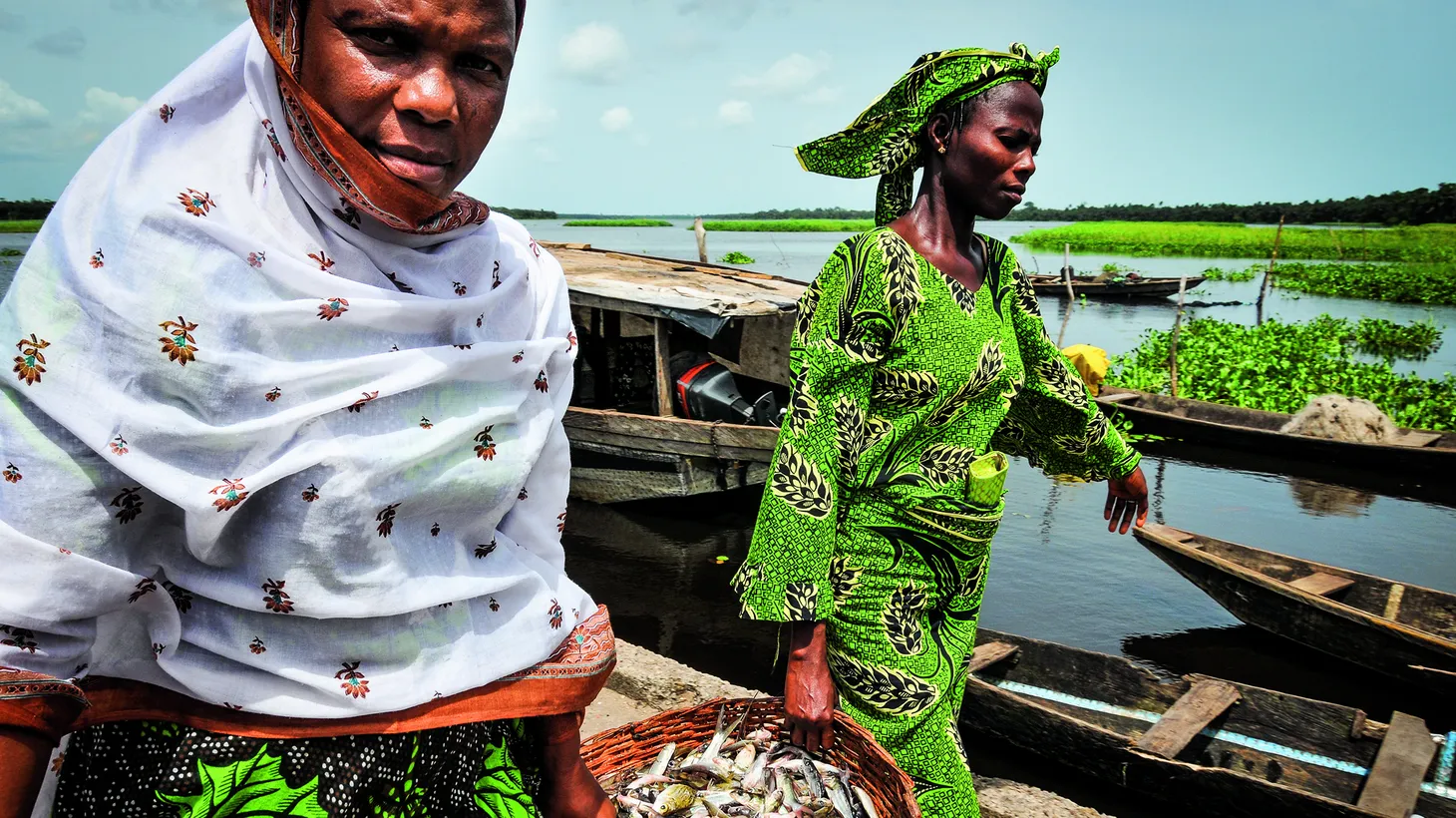 Women carry a basket of fish in Lagos, where food writer Yewande Komolafe returned after 20 years to reconnect with the home she left behind.