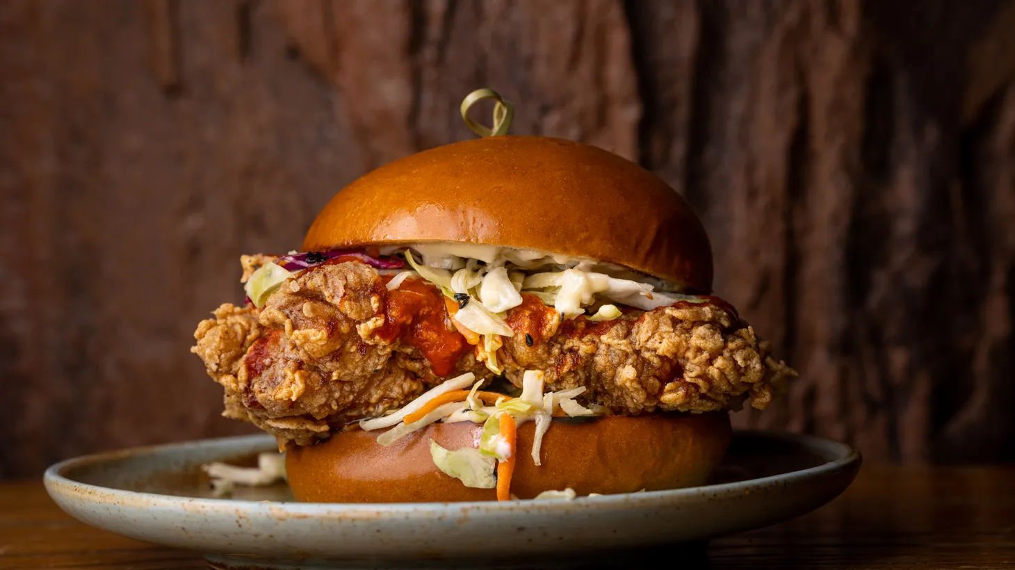 A fried chicken sandwich is featured on the menu at Mo's House of Axe.