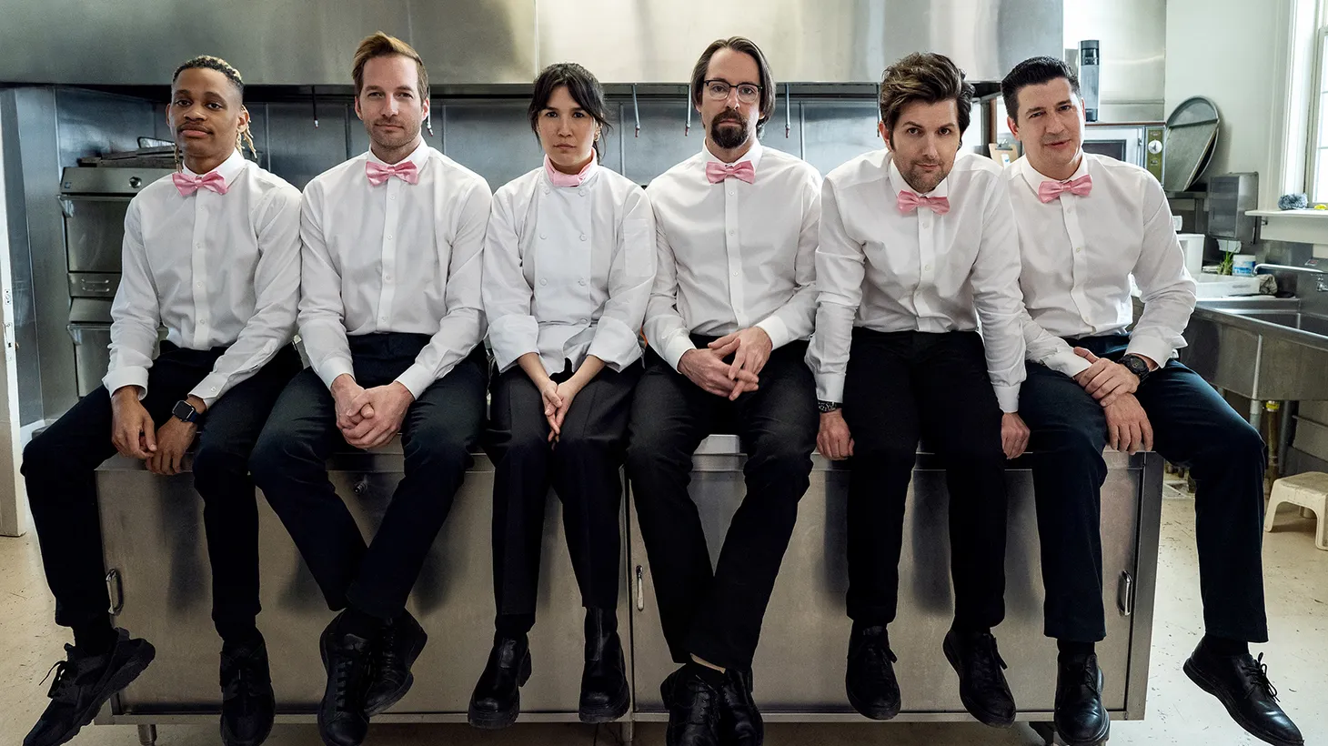 (From left to right) Tyrel Jackson, Ryan Hansen, Zoe Chao, Martin Starr, Adam Scott, and Ken Marino play brokedown catering waiters waiting for their big break in "Party Down."