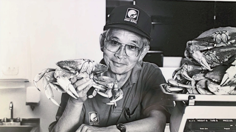 Hank "Toto" Kagawa holds up a crab at Fish King, the Glendale store he owned and ran.