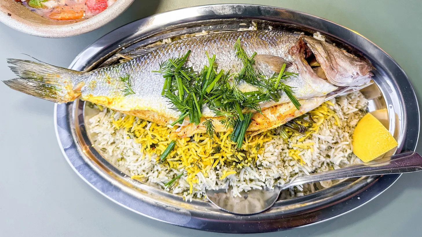 A whole roasted branzino stuffed with herbs and served on top of herbed rice was the centerpiece of Azizam's Nowruz menu.