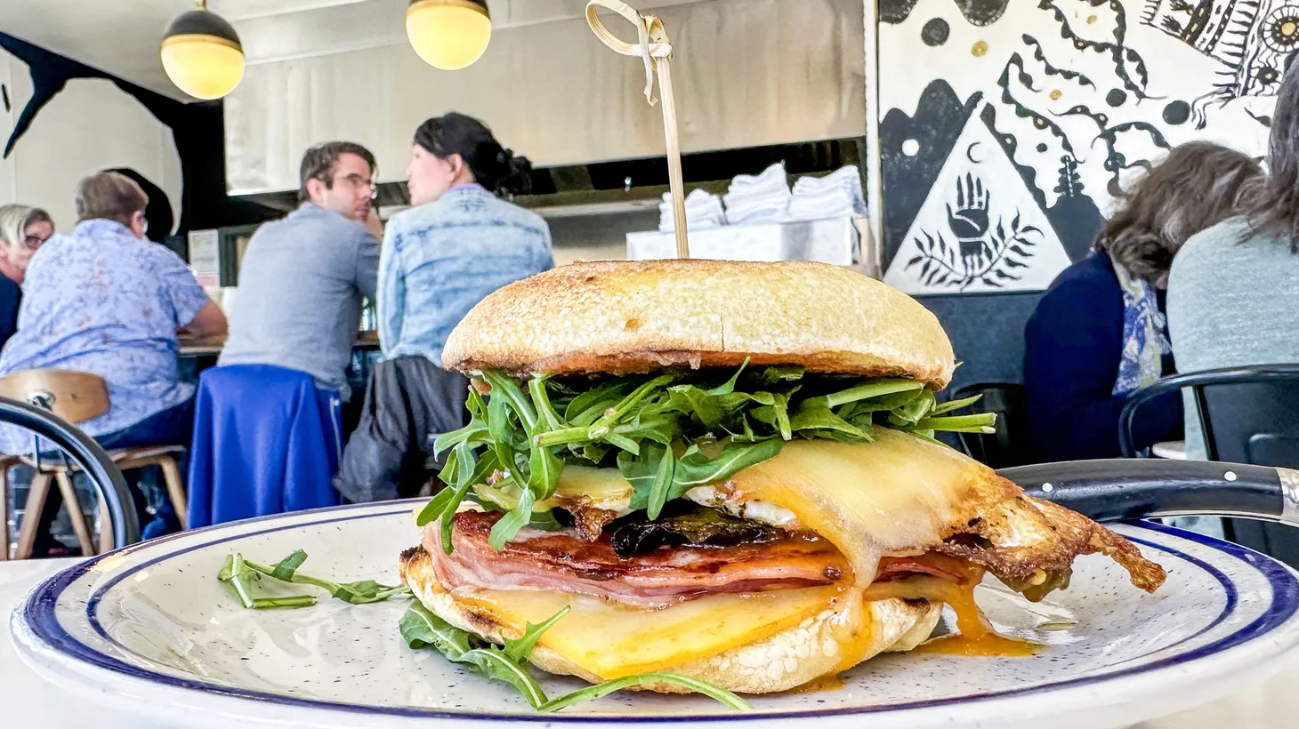 Griddled ham makes friends with a fried egg, muenster cheese, smoked shishito peppers, date jam and arugula in La Copine’s breakfast sandwich.