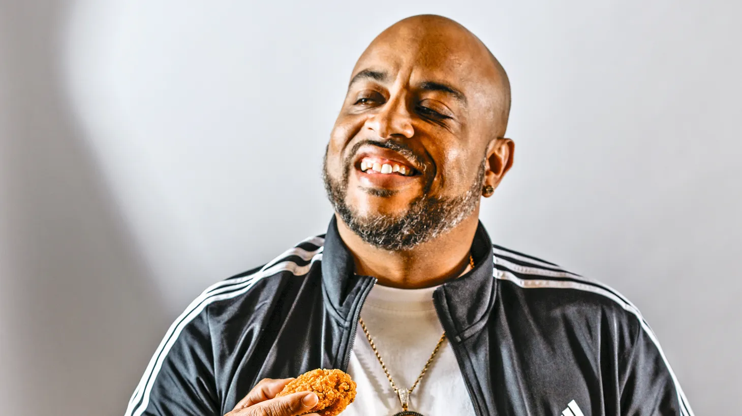 Toriano Gordon enjoys a piece of his vegan fried chicken, which he makes with plant-based Better Chew Shredded Chicken and plenty of seasoning.