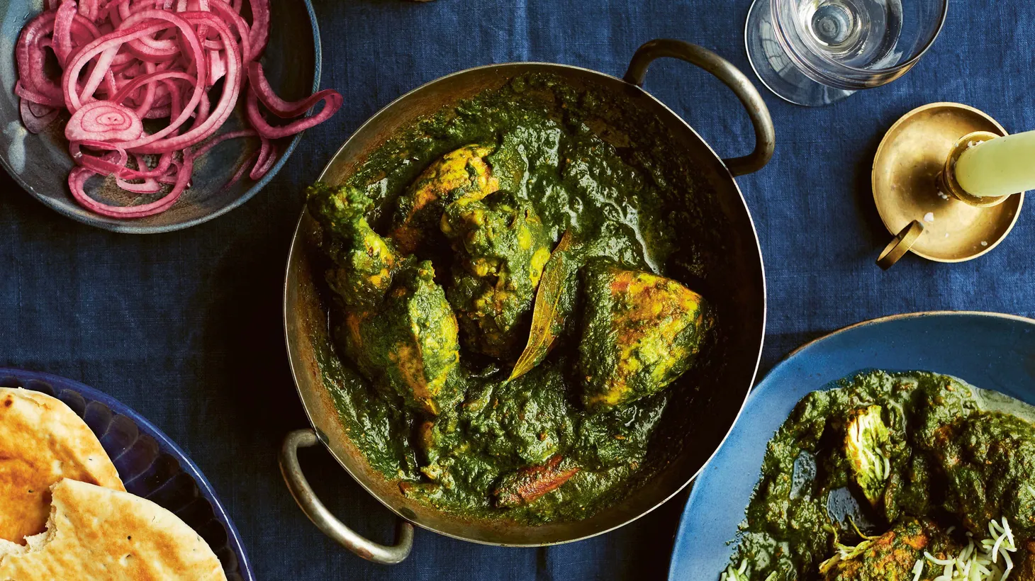 Marrying green, leafy vegetables with meat is the hallmark of North Indian cooking. This classic palak, or spinach and chicken curry, is spiced with ginger, coriander, and garam masala, and is often included in thalis of the region.