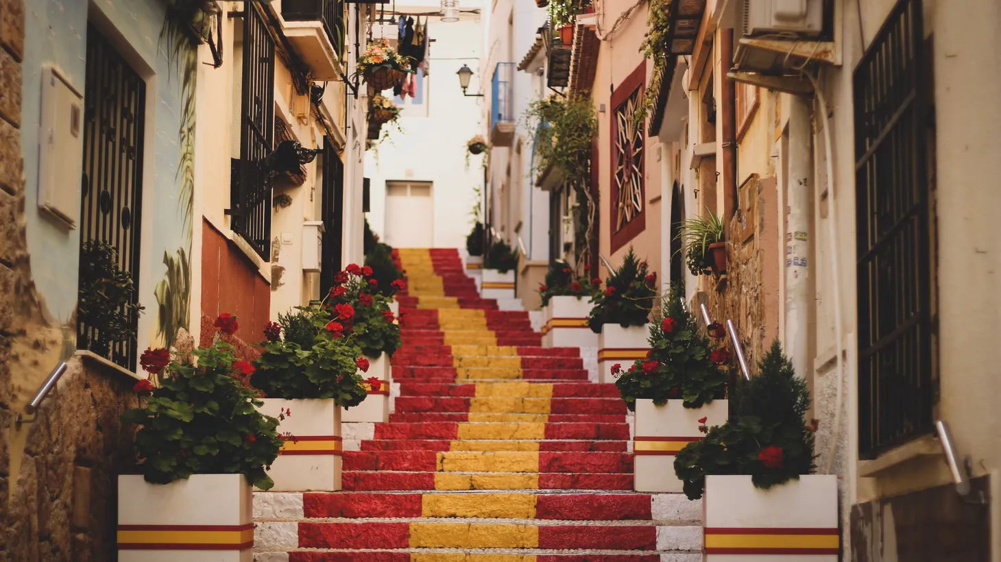 Steps in Old Town, Calp, Spain, are painted yellow and red, in keeping with Spain's flag.