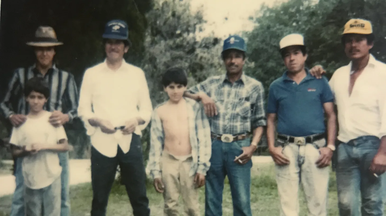 Lalo García (center) idolized his father Lupe (to his left in the white shirt), enjoying his time working in the fields and the road trips they took to get from farm to farm.