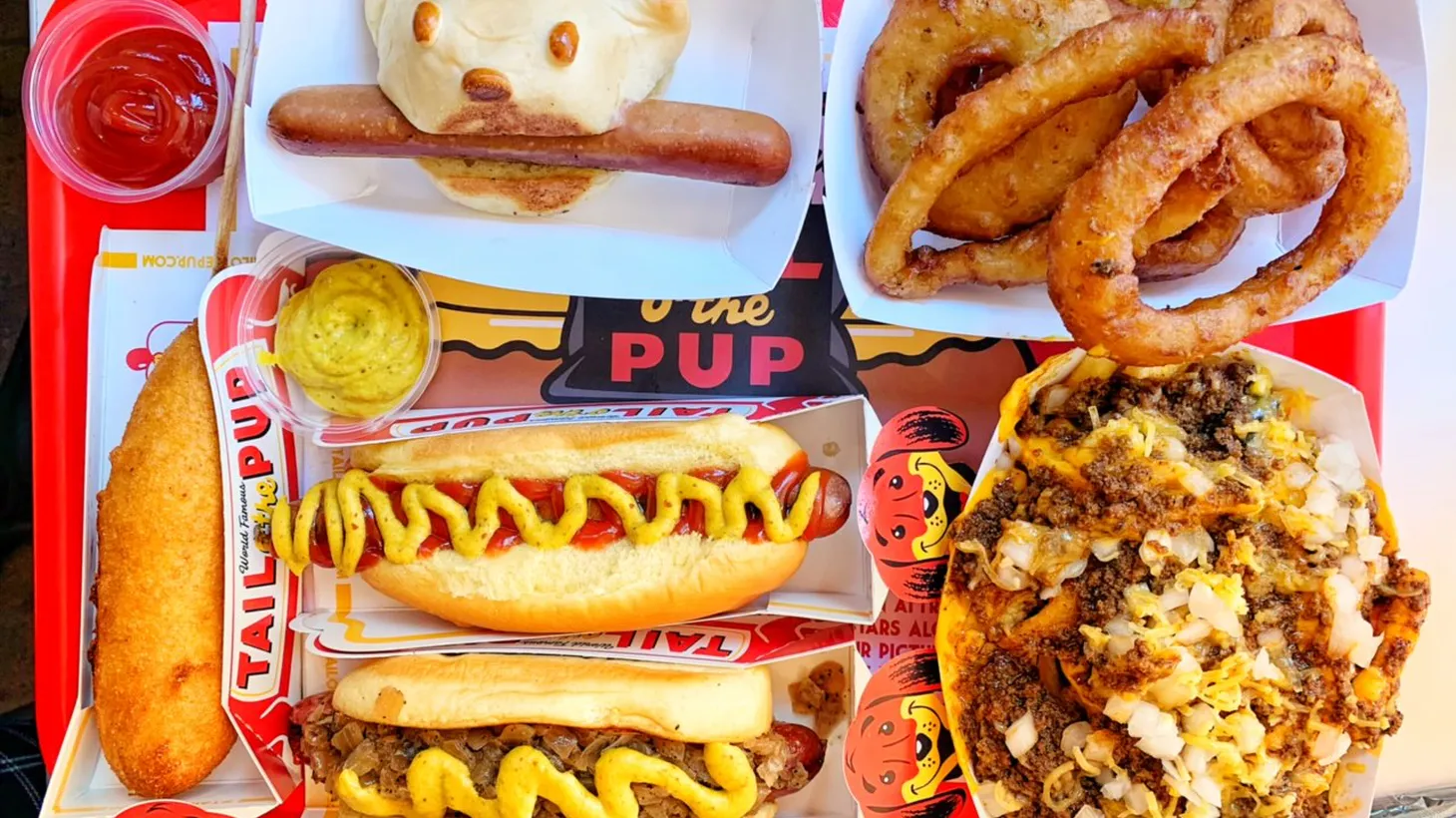 Chili fries, corn dogs, onion rings, and the 1946 Pup, an homage to the original split hot dog, are just a few items on the Tail O’ the Pup menu that “will make you smile.”