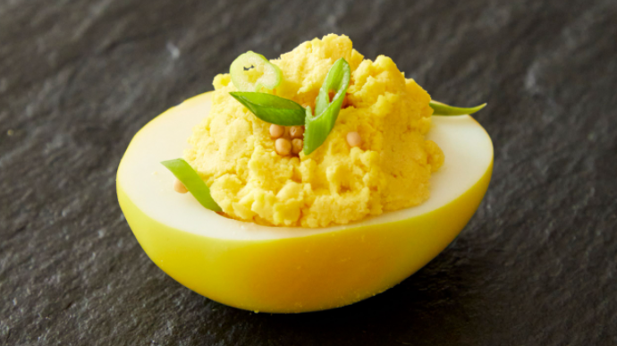 Adding turmeric to turn the egg whites a vibrant yellow, these deviled eggs can take your potluck or Easter spread to the next level.