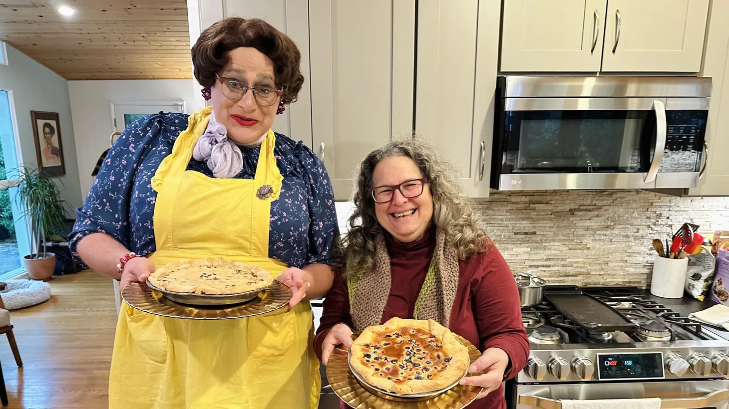 The pie-loving Bertha (left) and Good Food host Evan Kleiman show off a pair of pies after one of Bertha's baking classes.