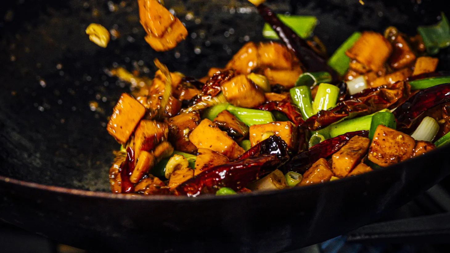 Sichuan peppercorns, chilis, peanuts, and scallions give sweet potatoes a kung pao spin.