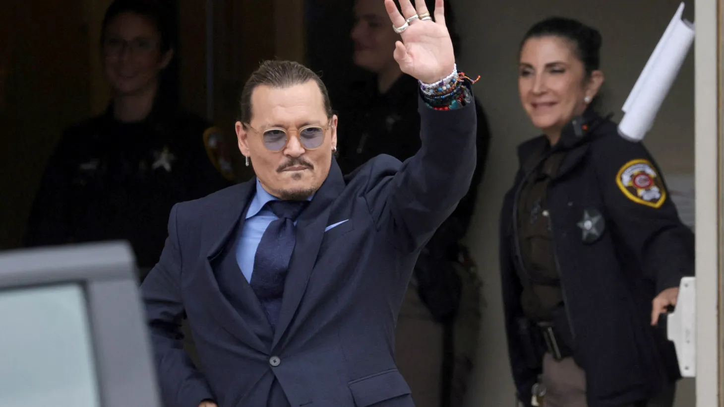 Actor Johnny Depp gestures as he leaves the Fairfax County Circuit Courthouse following his defamation trial against his ex-wife Amber Heard, in Fairfax, Virginia, U.S., May 27, 2022.