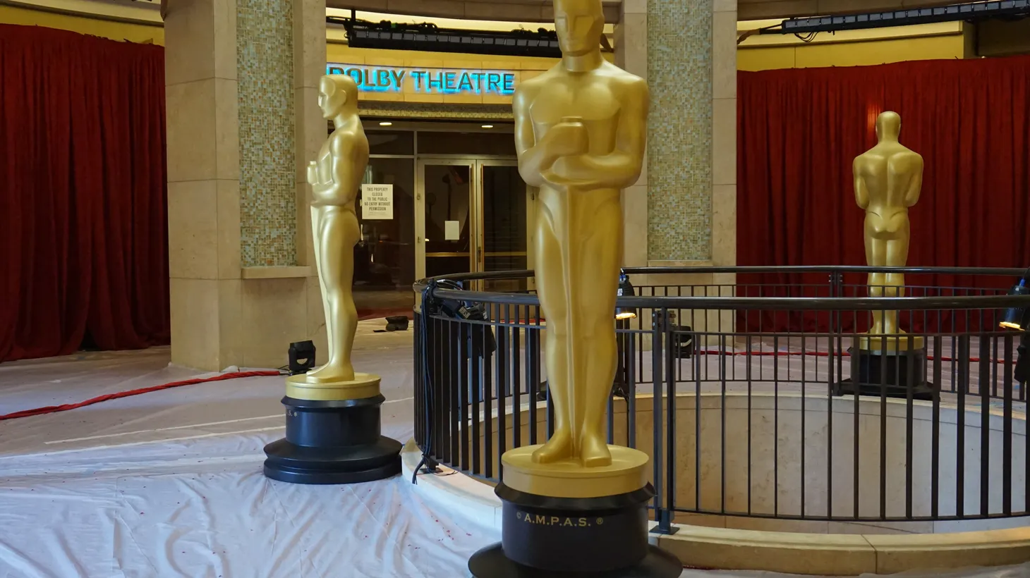 Large golden Oscar statues guard the entrance to the Dolby Theatre where the Academy Awards are held.