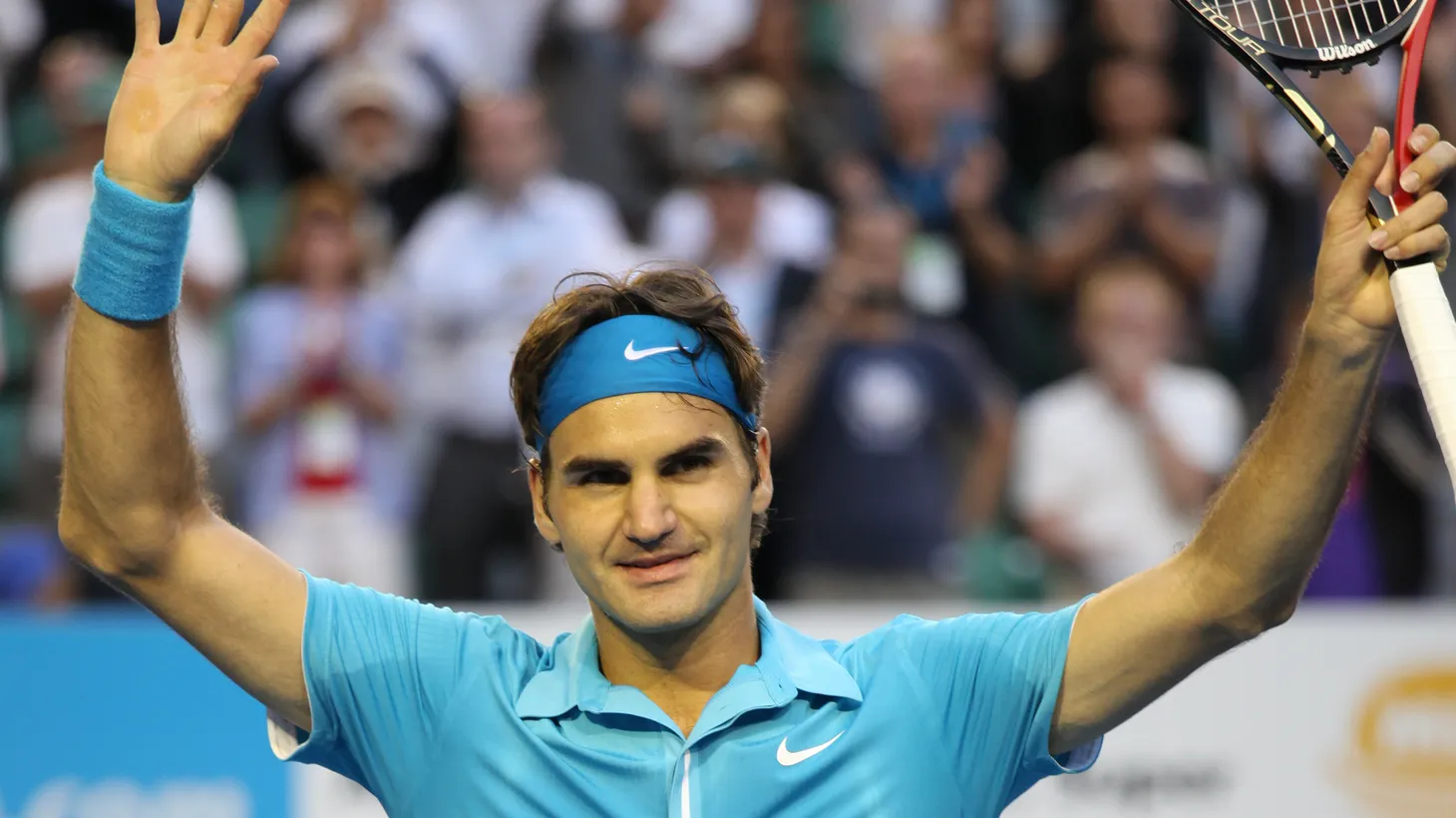 Roger Federer waves to the crowd after a win in the 2010 Australian Open. “He so enjoyed playing tennis, and came to terms with that period when he was not winning any grand slams,” says writer Geoff Dyer. “And so why should he stop doing this thing that he liked doing so much?”