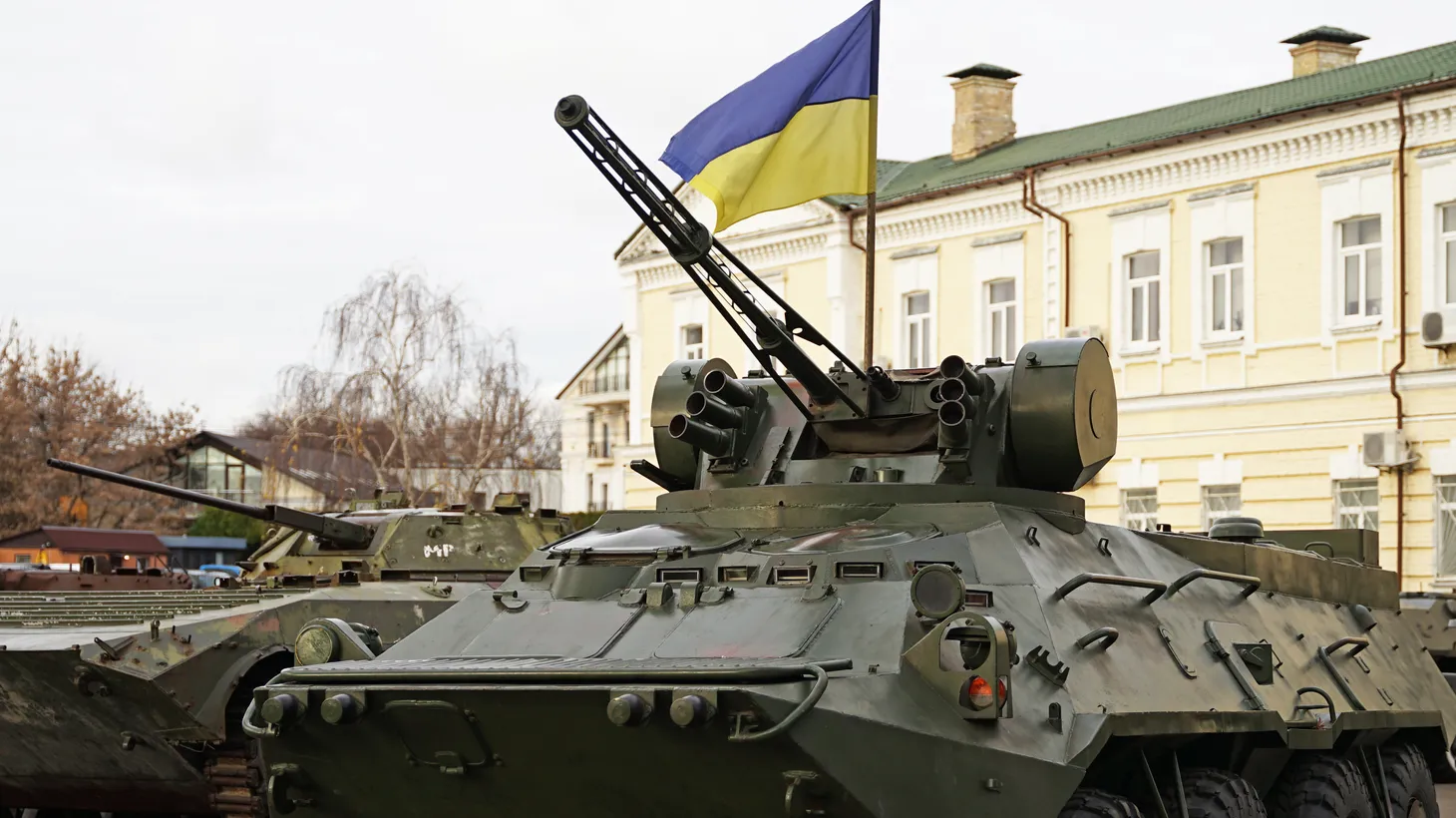 Army troops transporter and tank with Ukrainian flag, Kyiv Ukraine.