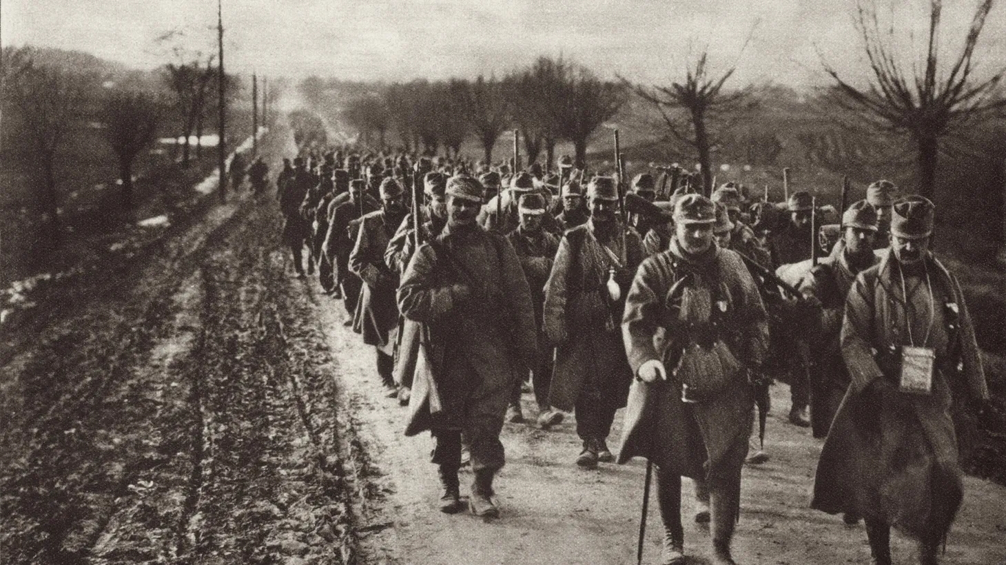 An Austrian soldier column marching through the flat country of Eastern Europe during WWI, 1914-17.