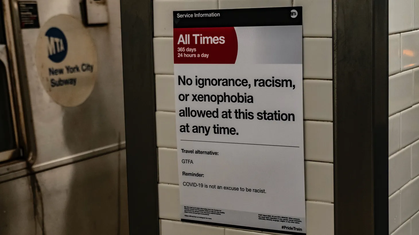 The movement and travel restrictions instituted in NYC are having significant economic impacts. A sign reads "No ignorance, racism, or xenophobia" allowed.