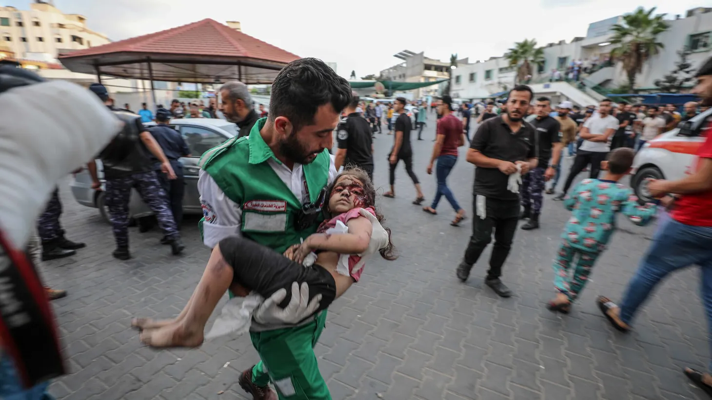 Medics transport an injured Palestinian child into Al-Shifa hospital in Gaza City following an Israeli airstrike on October 11, 2023.
