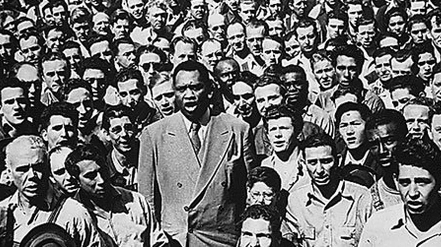 Paul Robeson, in 1942, leads Oakland shipyard workers in the singing of the National Anthem.