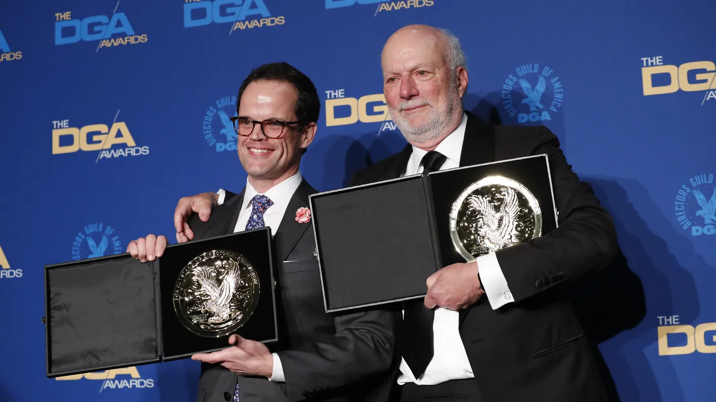 Andy Fisher (L) and James Burrows, directors of “Live in Front of a Studio Audience Norman Lear's All in the Family & The Jeffersons” pose with their medallions after winning for Outstanding Directorial Achievement in Variety/Talk/News/Sports at the 72nd Annual Directors Guild Awards in Los Angeles, on January 25, 2020.