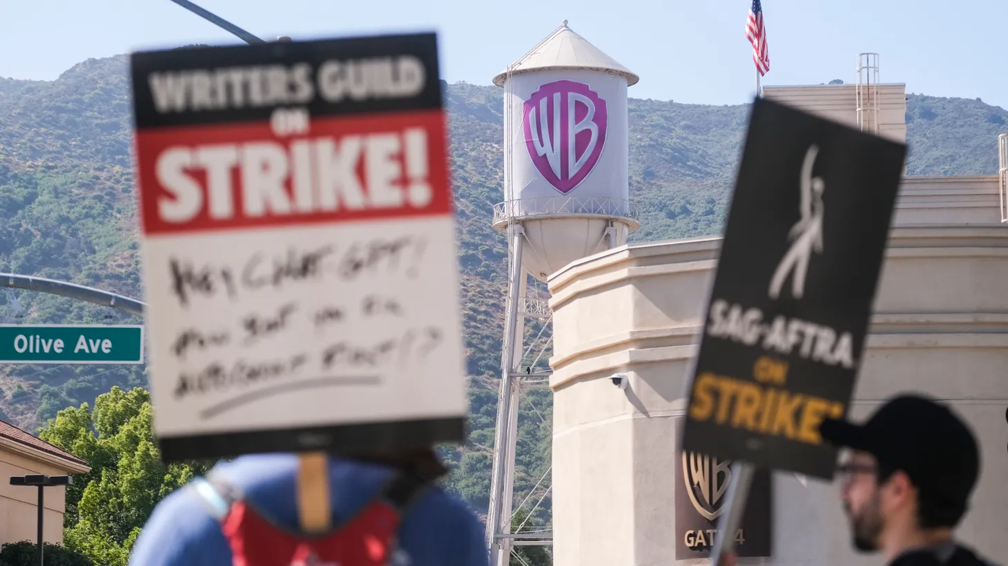 Members of the writers and actors’ guilds picket outside the Warner Bros. studios in Burbank, on Tuesday, July 18, 2023.