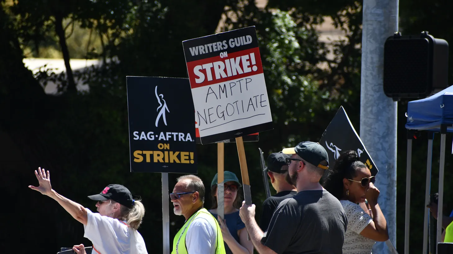 A group of SAG-AFTRA members protest current contract negotiations and worker rights in front of Warner Bros. Studio in Burbank, CA on July 27, 2023.