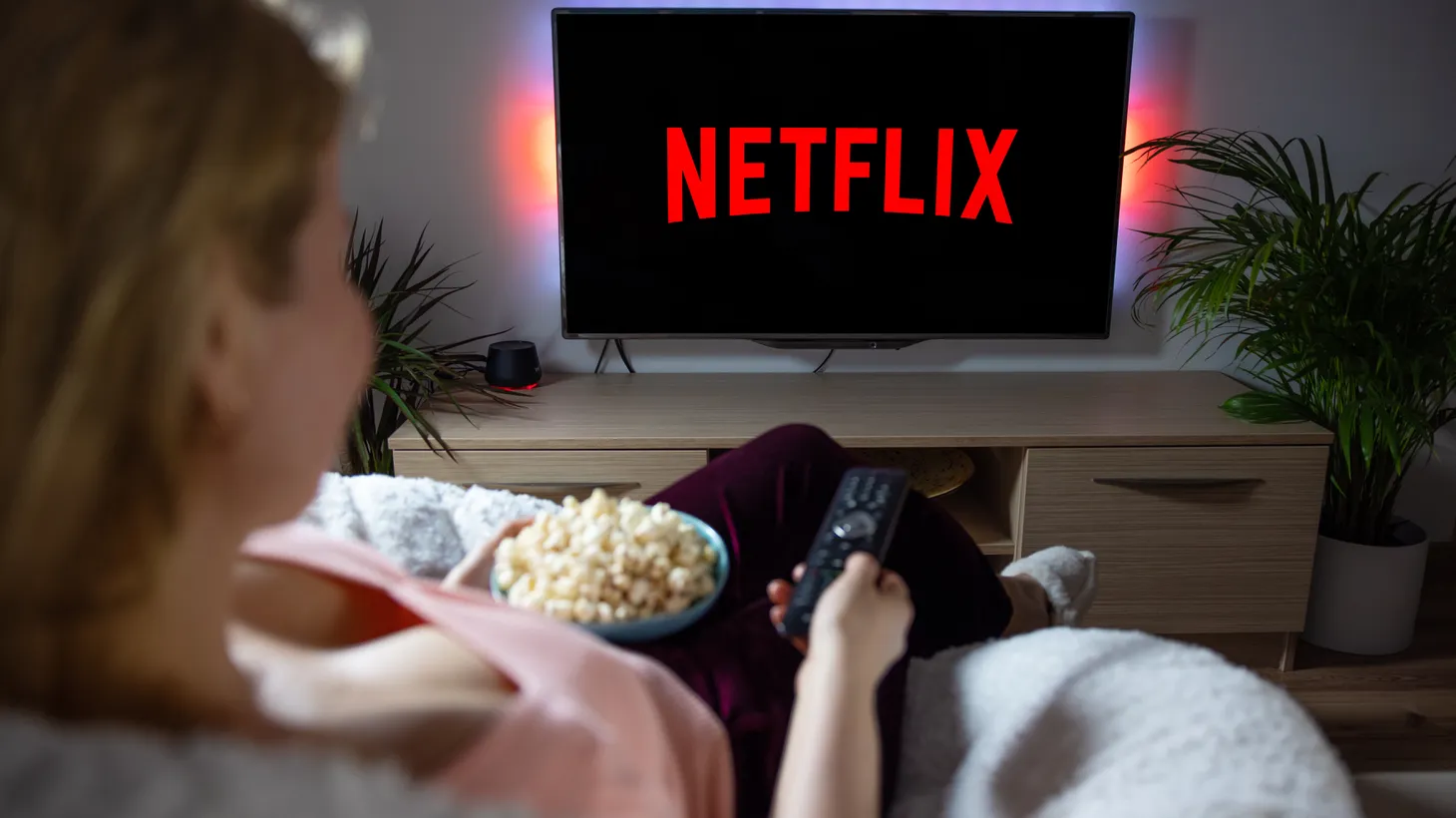 Woman accesses Netflix on a television set.