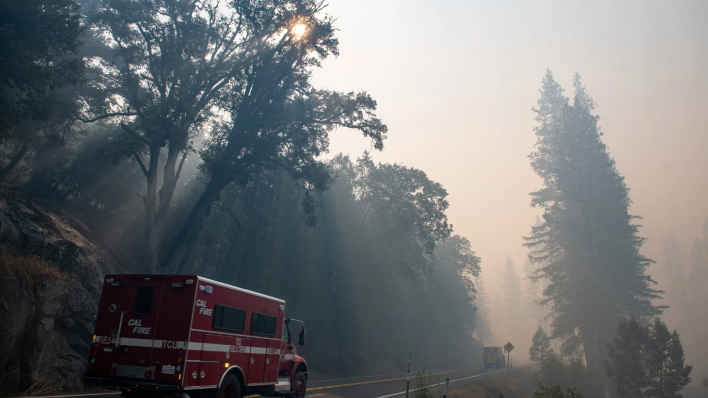 A CalFire truck drives on a smoke-filled Highway 50 between Pollock Pines and Strawberry on Tuesday, Aug. 31, 2021, as the Caldor Fire burns nearby.