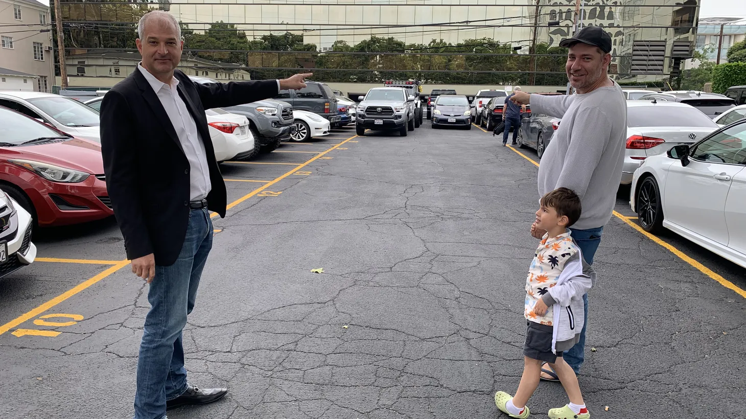 Developer Leo Pustilnikov (right) and his son are with attorney Dave Rand (left), pointing to the spot on what’s now a Beverly Hills parking lot where Pustilnikov plans to build apartments using the “builder’s remedy.”