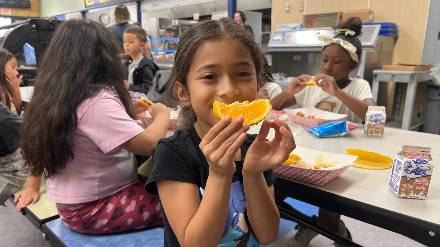 Baldy View Elementary School student Dessilouu Padilla is all smiles when she learns her orange was grown on a nearby farm.