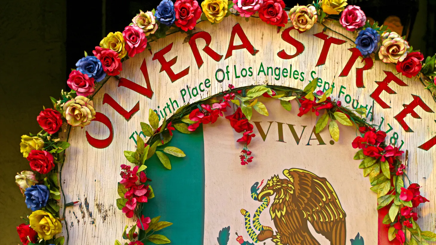Olvera Street is a market, a commercial theme park, and a living museum — full of restaurants, shops, and stalls overflowing with candy, Mexican handicrafts, and cheap souvenirs. Most businesses have been in the same family for generations.