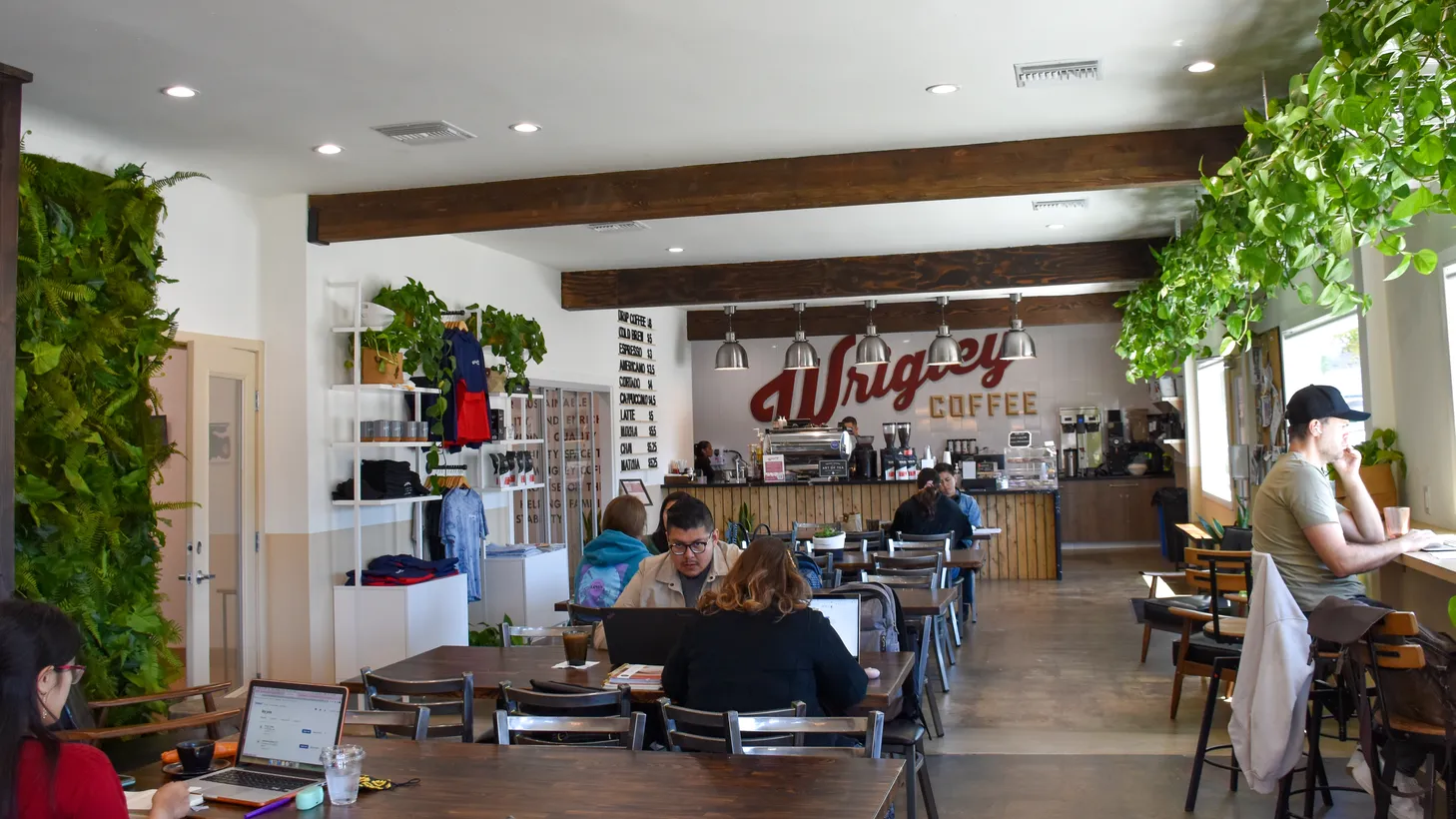Customers chat, work and sip coffee at Wrigley Coffee in Long Beach, which recently opened as part of a program to help train people who face housing insecurity.
