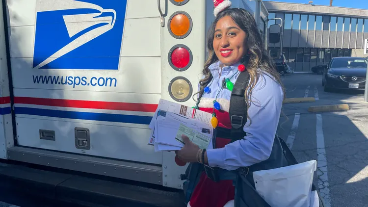 U.S. Postal Service mail carrier Lesly Gonzalez works 10-hour days leading up to Christmas. Does the heavy workload dampen her holiday spirit?
