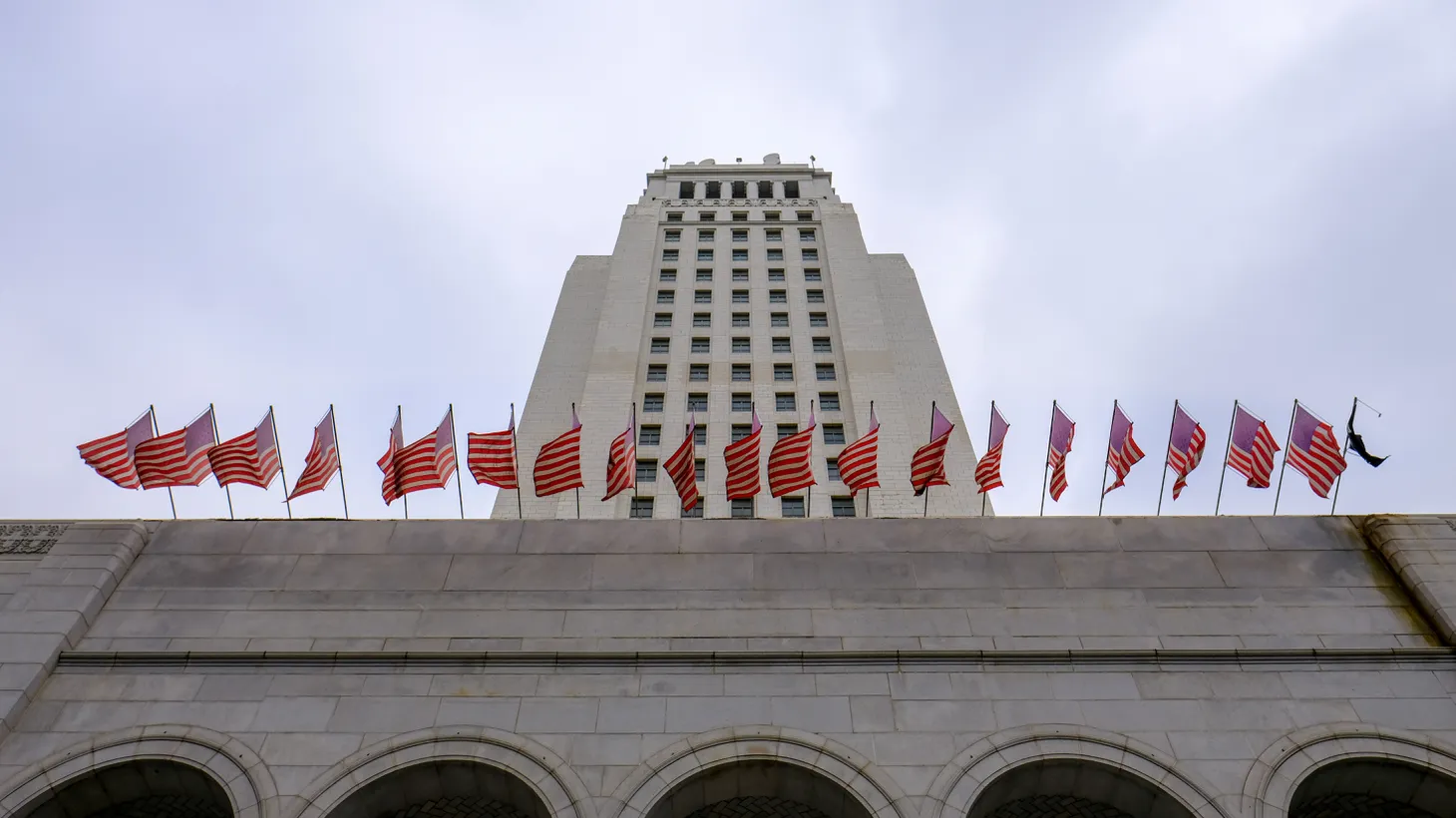 LA City Hall is seen on a cloudy day, October 14, 2022. “Let's not continue to invest in a system that's already not working for the city. Let's try … a new vision of how to do things, a vision that other cities have tried, and it's been very effective,” says Hugo Soto-Martinez.