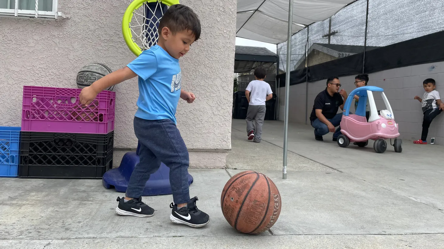 Elijah Rascon shoots hoops during play time at Lorenzo Family Child Care in Boyle Heights.
