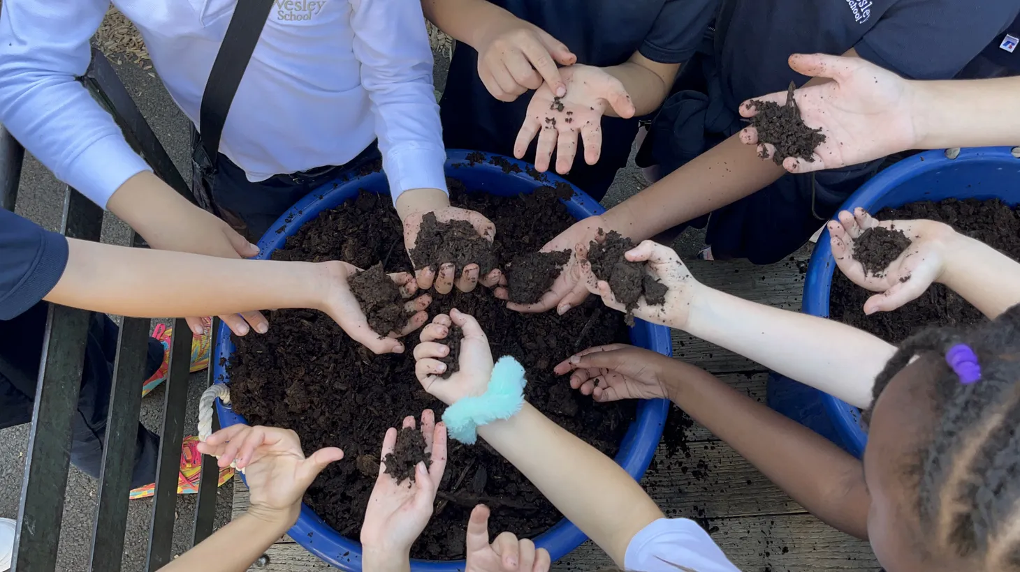 Students at The Wesley School in North Hollywood hold the compost they created after a year of collecting their food waste.