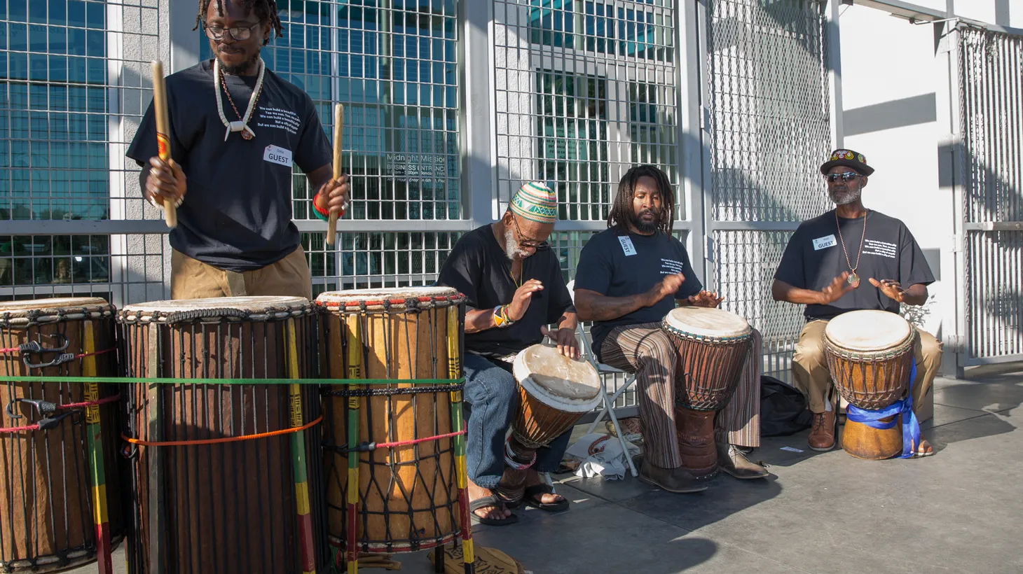 Street Symphony musicians play drums.