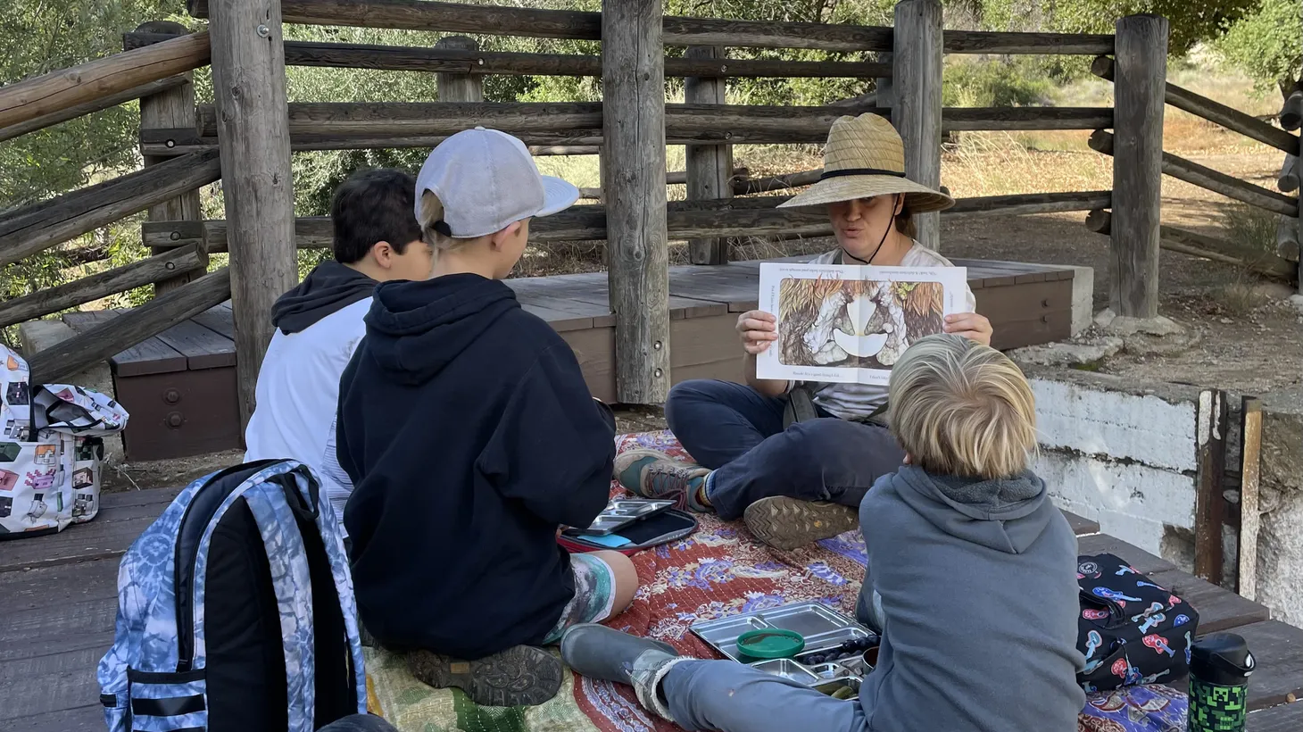 Children’s Forest School Co-founder Madlen Sarkisyan reads a story to homeschooled kids in a Simi Valley park.
