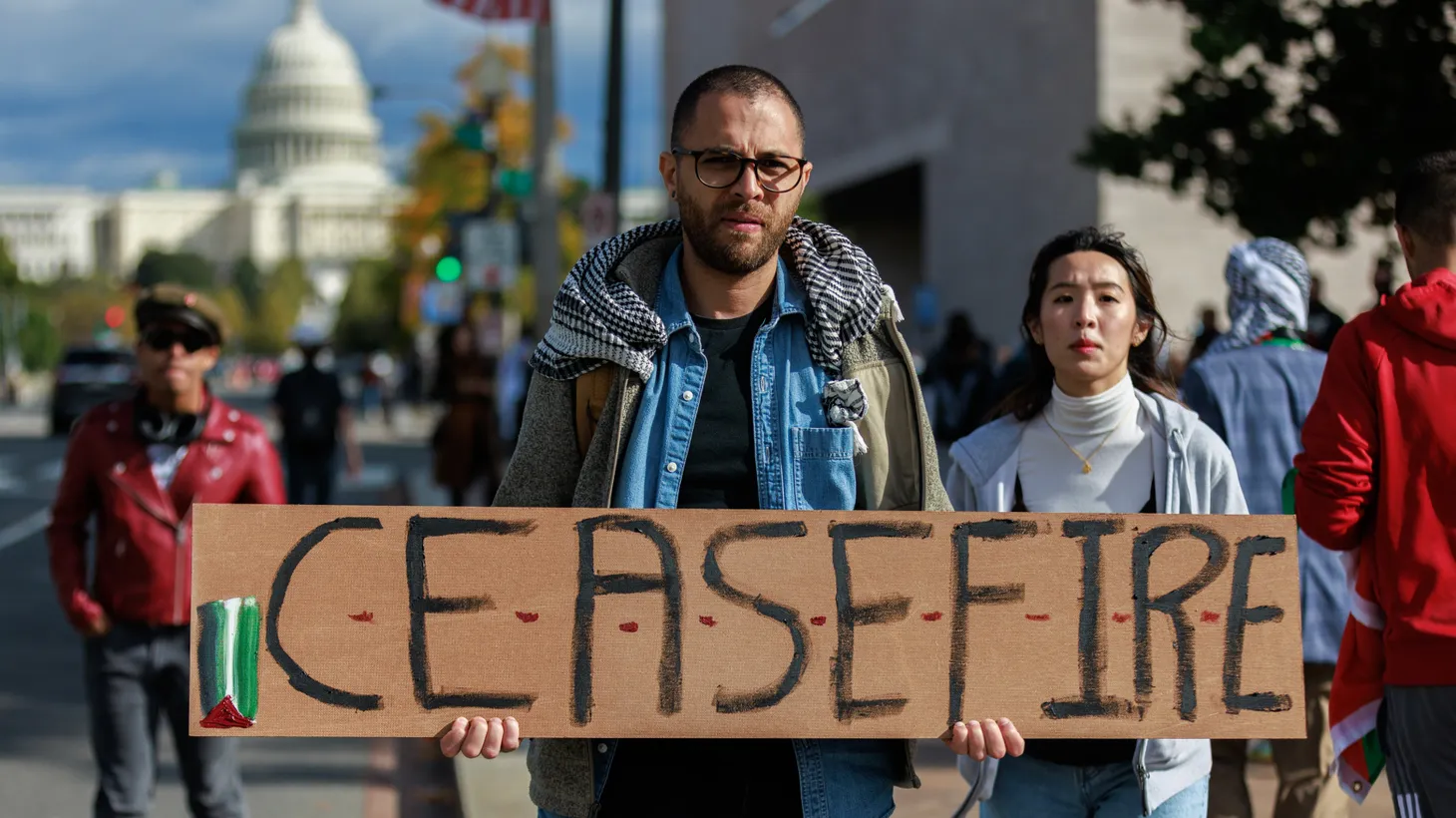 As the Israel-Hamas war escalates, a person holds a “ceasefire” sign on the National Mall in Washington, D.C. on October 21, 2023.