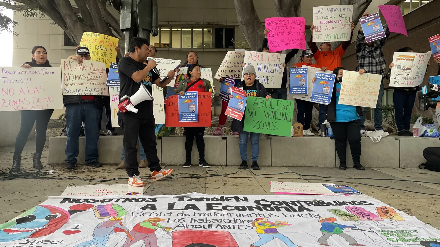 Sidewalk vendors rally in front of the Stanley Mosk Courthouse in Downtown Los Angeles ahead of a hearing on their lawsuit against the City of LA.