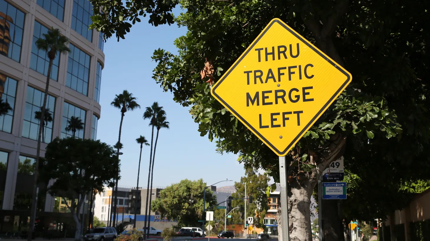 A sign in Burbank says, “Thru traffic merge left.” Studies have shown that zipper merging helps traffic flow better, but California transit officials don’t plan to adopt it as an official rule yet.