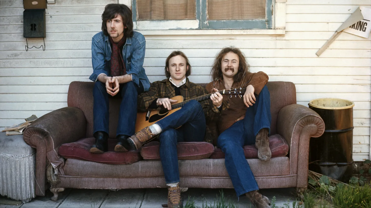 (L-R) Graham Nash, Stephen Stills, and David Crosby pose on a couch for their debut album cover.