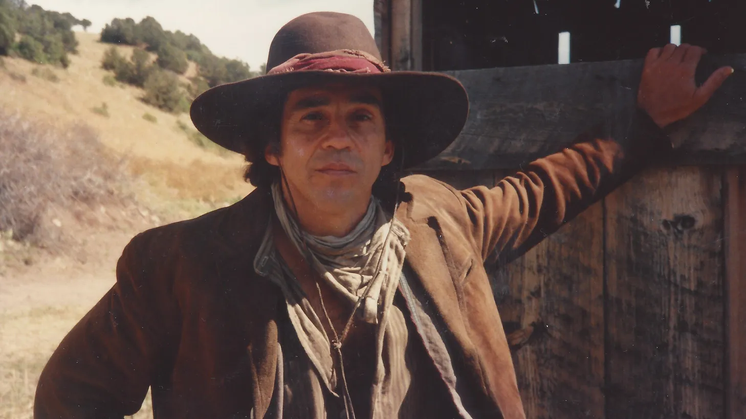 Pepe Serna relaxes behind the scenes on the set of the western “The Brave.”