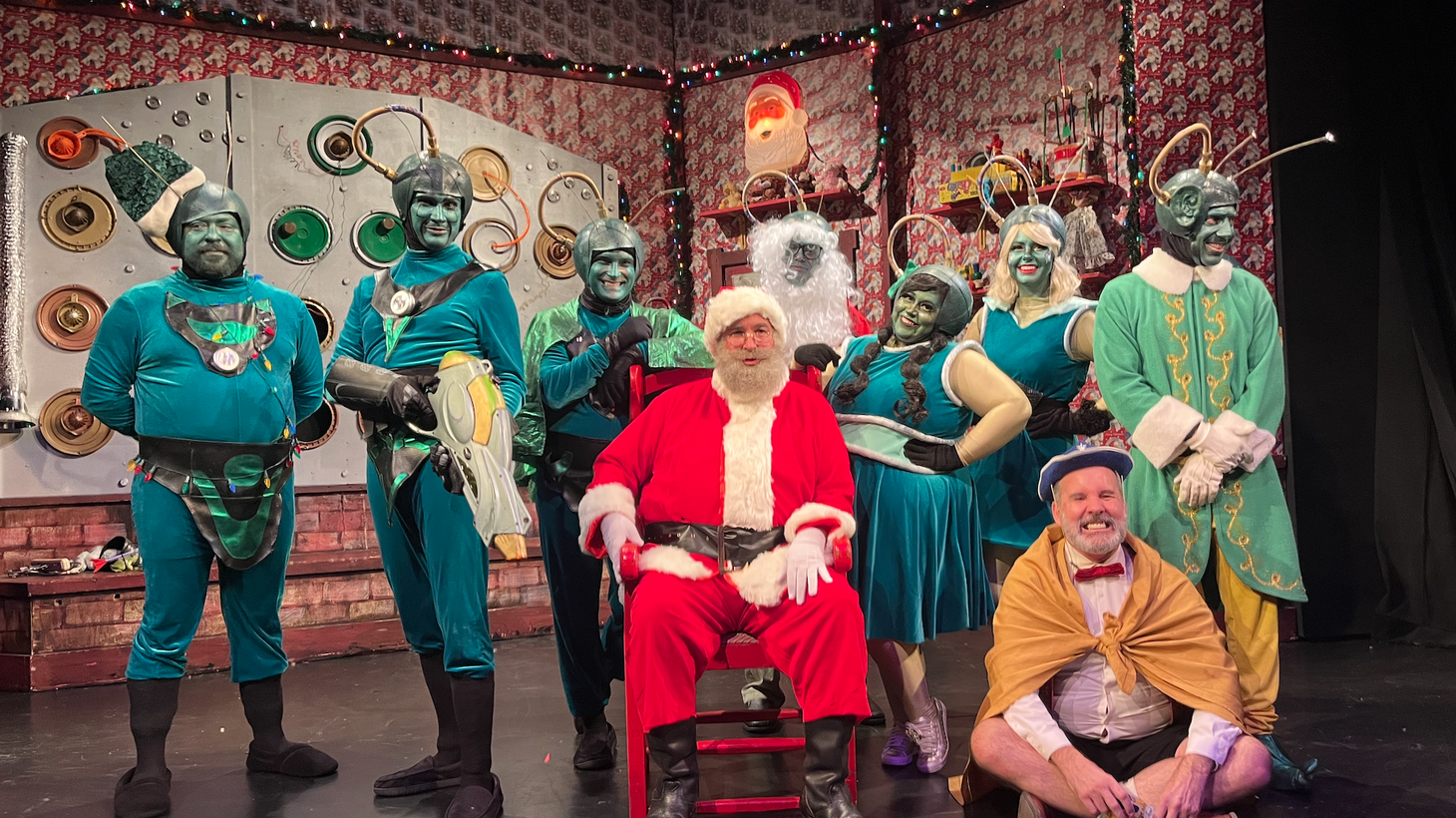 The 2023 cast of “Santa Claus Conquers the Martians” at the Maverick Theater in Fullerton gathers to take pictures with audience members after the show.