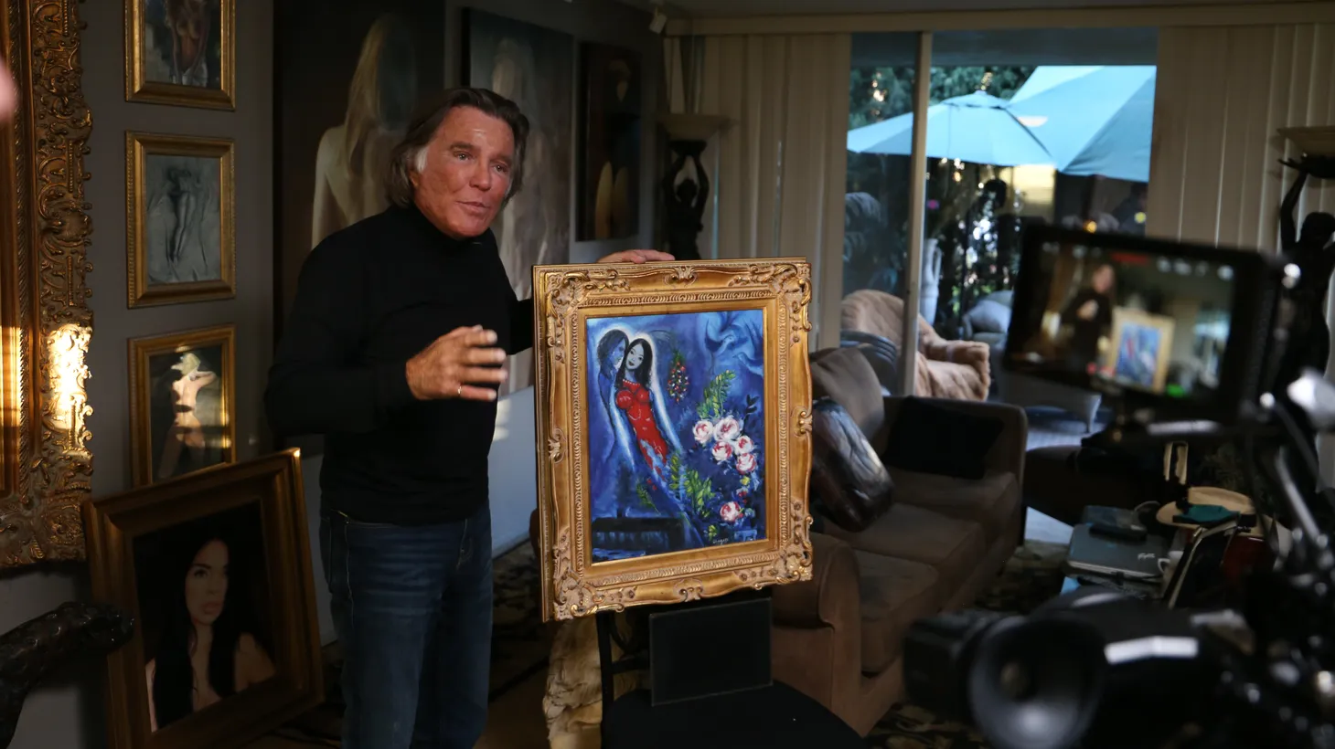 Tony Tetro has made thousands of high-quality forgeries of famous artists' work. He poses here with a Chagall imitation entitled “Fernanda and Me.”