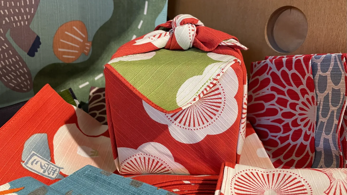 A box wrapped with cloth, using the Japanese wrapping technique of furoshiki, is part of a display in the Craft Contemporary Museum shop.