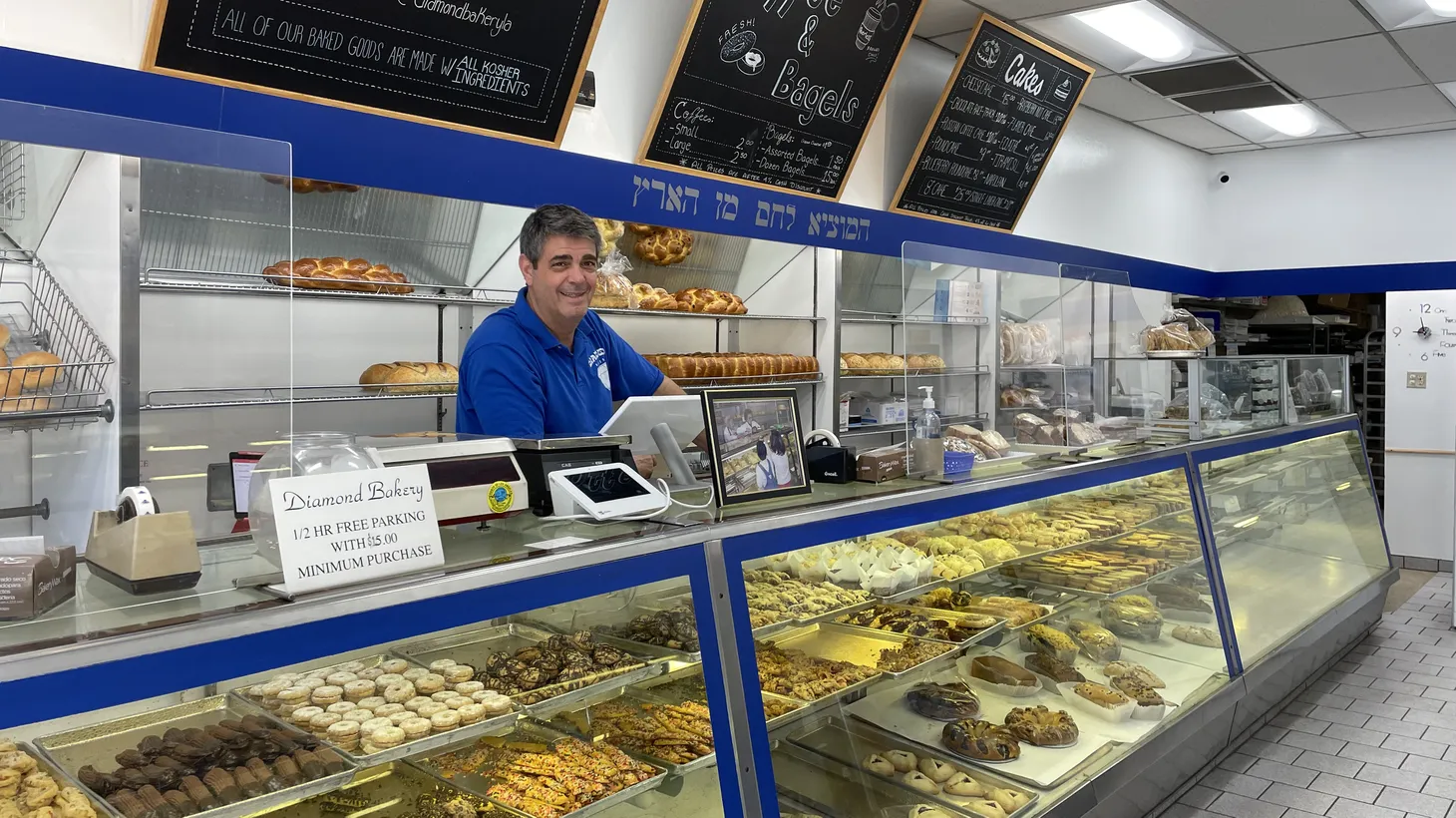 Owner Doug Weinstein stands behind the counter of Diamond Bakery, which was opened by a Jewish Holocaust survivor in 1946.