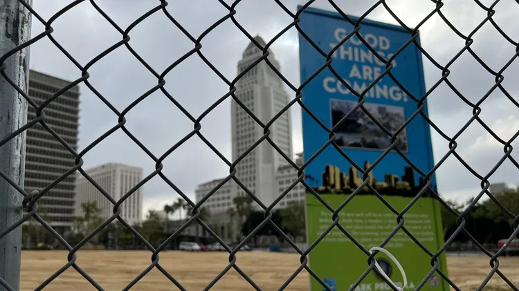 Across from LA City Hall, a vacant lot has signs that boast, “Good things are coming!” The signs have been there for a decade. What’s going on?